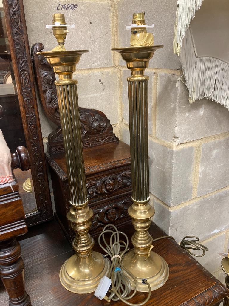 An adjustable gilt standard lamp and a pair of corinthian column lamps